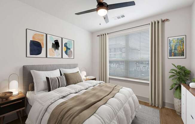 A bedroom with a large bed and a ceiling fan.