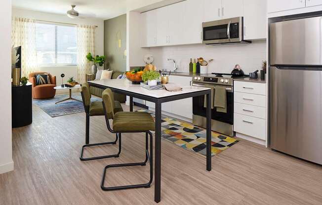 a kitchen and dining room with a table and chairs