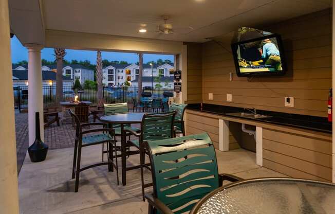 Picnic Grilling Area with TV at Abberly Crossing Apartment Homes by HHHunt, Ladson, 29456