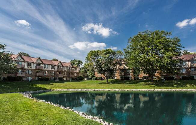 A large building with a pond in front of it.