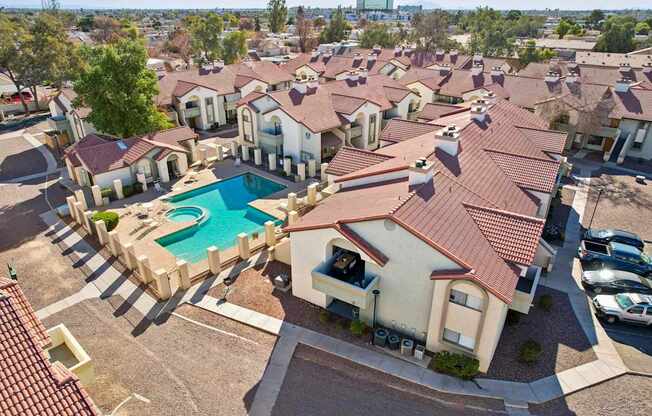 A large group of houses with a pool in the middle.