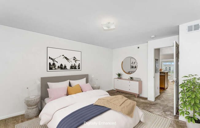 A bedroom with a bed, nightstand, and a painting on the wall at Colonial Pointe at Fairview Apartments, Bellevue, Nebraska