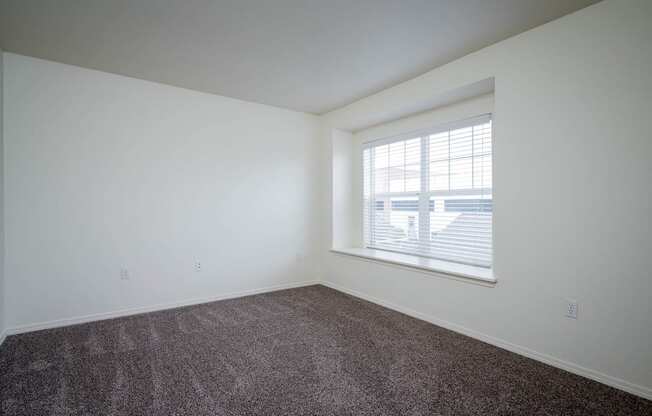 Village at Main Street | 2x2 Bedroom Two with Wall to Wall Carpeting and Light Filled Window