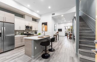 a kitchen with a counter top and a staircase