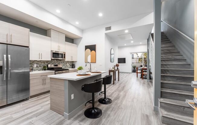 a kitchen with a counter top and a staircase