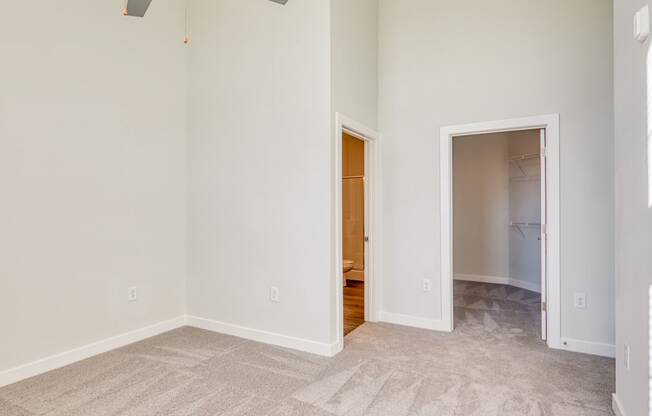 an empty bedroom with a door to a bathroom and a closet at The Bella at Westchester, Midlothian, 23113