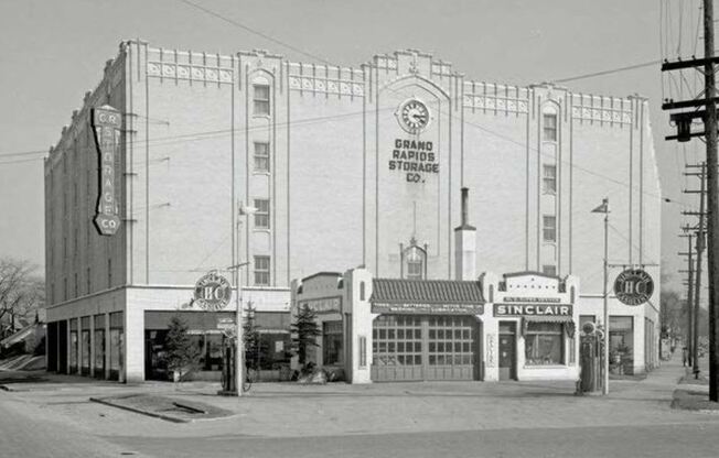 an old photo of a theater on a city street