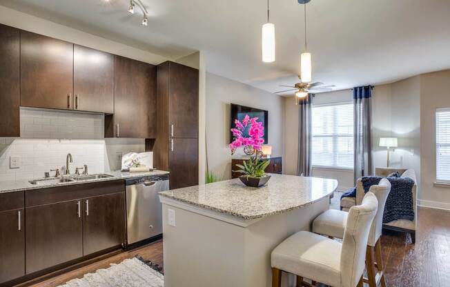 A kitchen with a sink, stove, and countertop.
