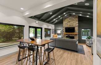 A modern dining room with a wooden table and chairs.