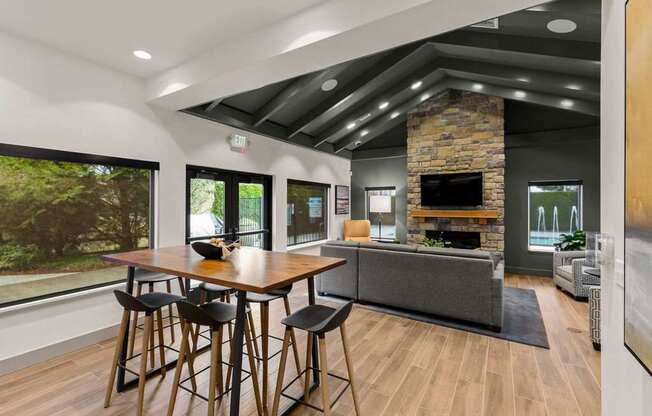 A modern dining room with a wooden table and chairs.