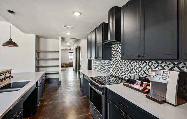 a kitchen with black cabinets and white countertops