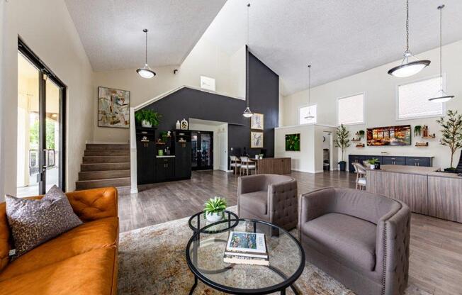 a living room with couches and chairs and a table