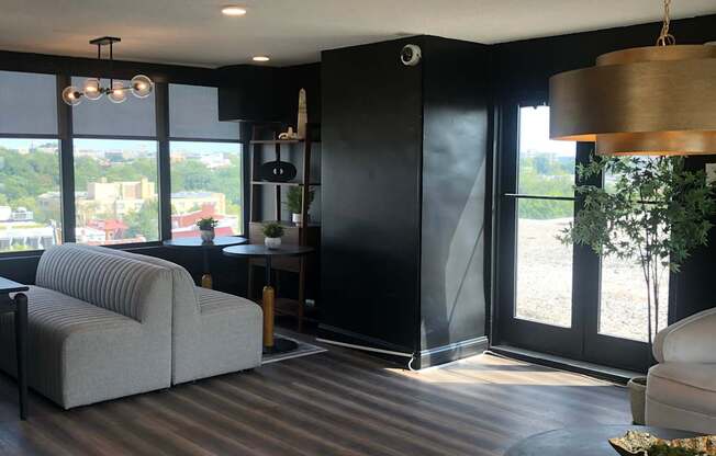A view from the top of a staircase looking down at a black couch.