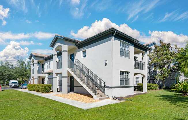 A modern two-story house with a white exterior and a black roof.