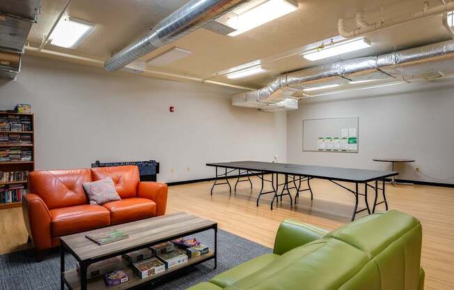 a game room with a ping pong table and couches