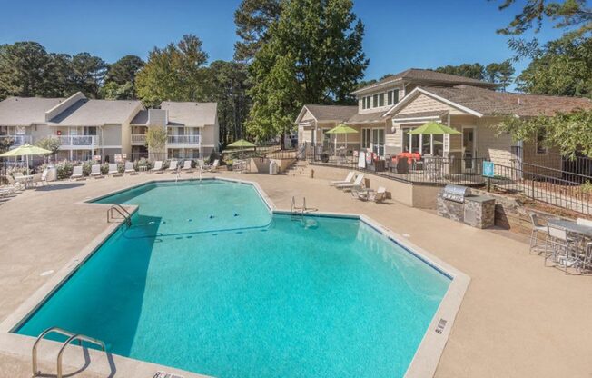 a resort style pool with a building in the background