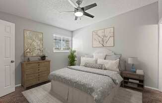 A bedroom with a bed, dresser, and ceiling fan.