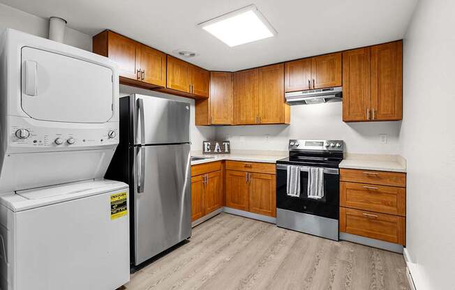 A kitchen with a white fridge, stove, and oven.