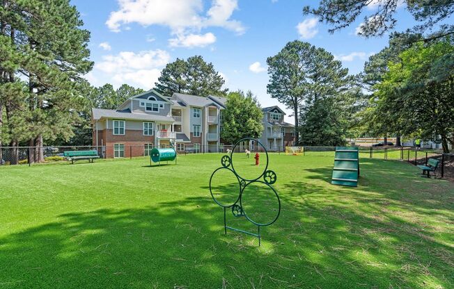 a park with a playground and houses in the background