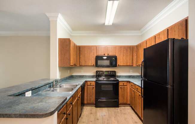 Modern kitchen with stainless steel appliances and ample counter space at Angel Landing apartments in Pensacola, FL