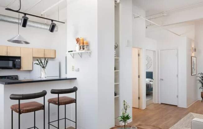 A modern kitchen with a bar area and a dining area.