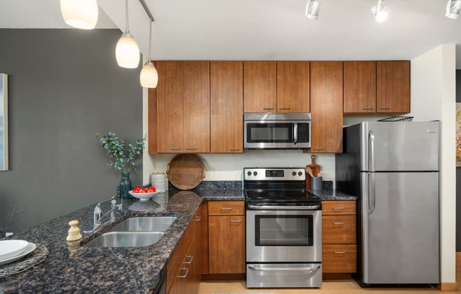 a kitchen with granite counter tops and stainless steel appliances