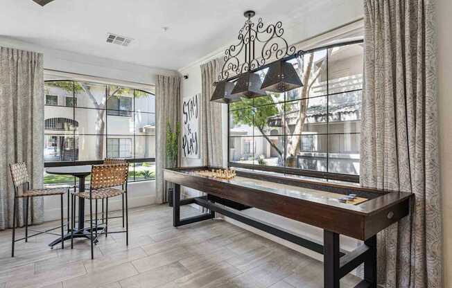 A dining room with a wooden table and chairs. at Lazo Apartment Homes, Chandler, AZ 85225