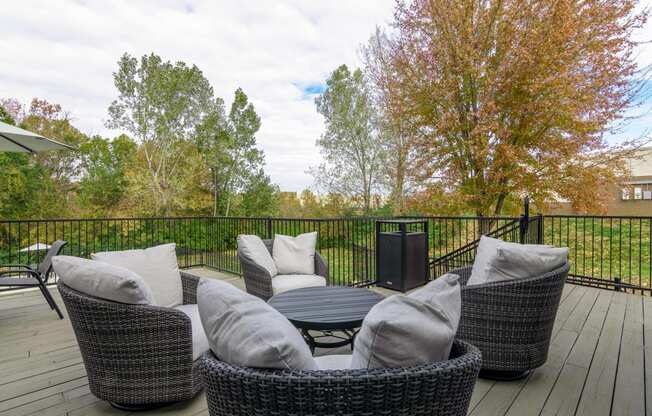 a patio with chairs and a table on a deck