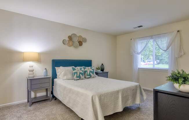 a bedroom with a bed and a window