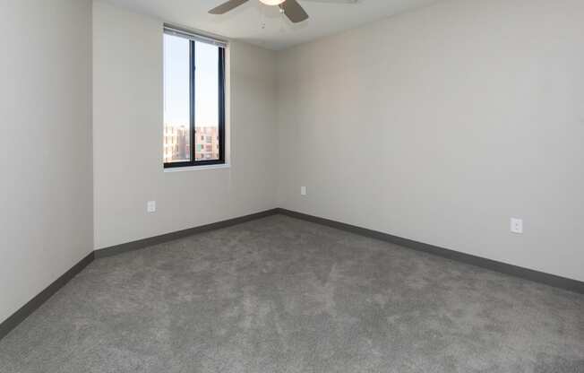 Spacious living room with neutral walls and ample natural light.