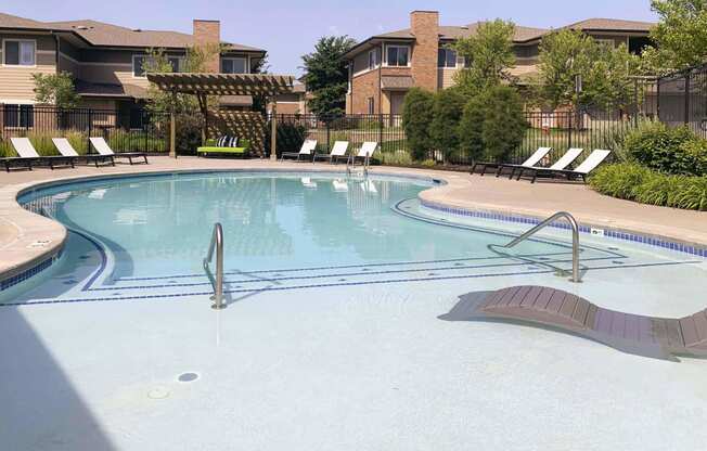 Resort style swimming pool with sun tanning loungers at North Pointe  Villas Lincoln Nebraska