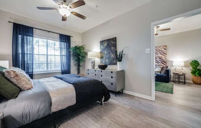 a bedroom with a bed and a ceiling fan