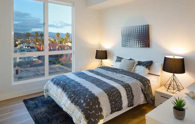 a bedroom with a bed and a large window