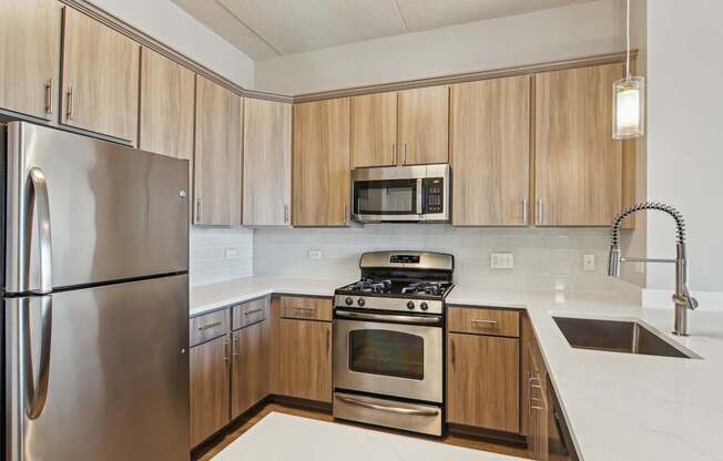 A kitchen with wooden cabinets and stainless steel appliances.