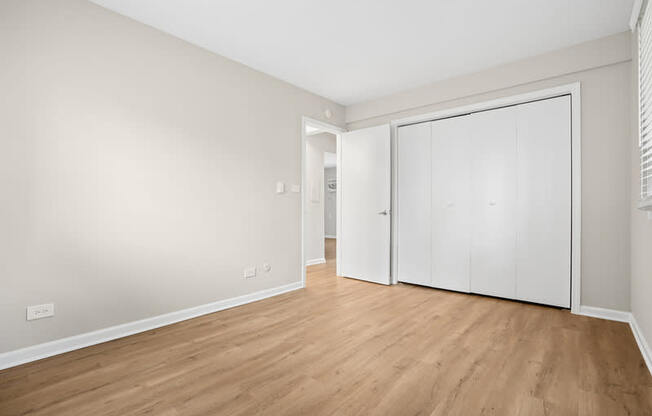A room with a white door and a white wall.
