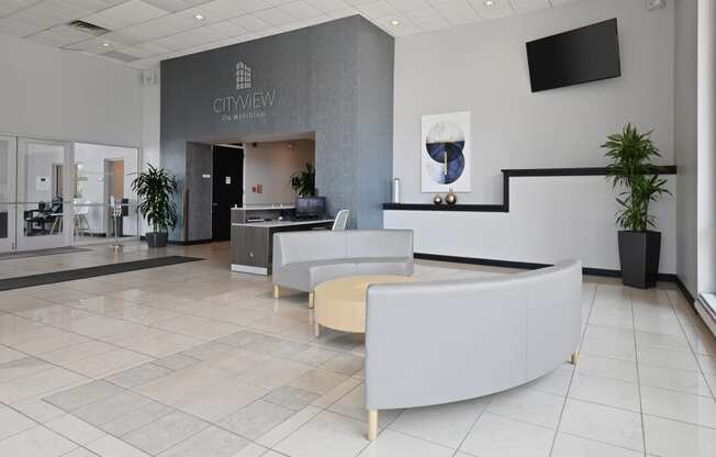 a lobby with chairs and a reception desk in a hospital