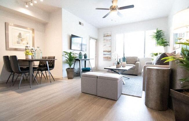 a living room and dining room with a ceiling fan