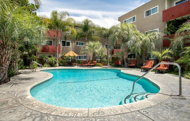 Woodland Hills CA Apartments for Rent - Lombardi - Sparkling Pool Surrounded by Palm Trees and Lounge Seating