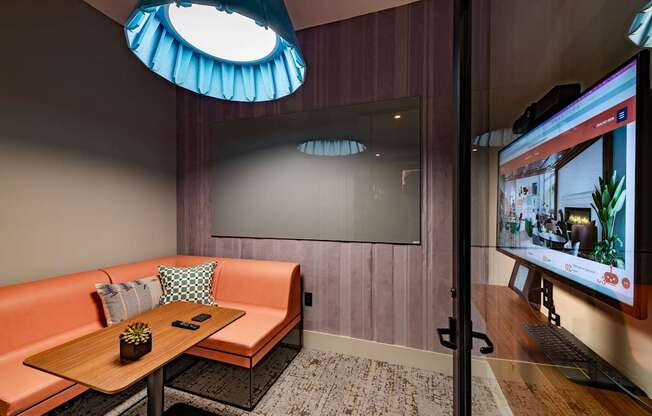 a room with a couch and a table and a television