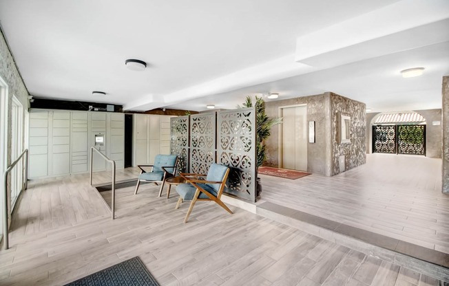 a large lobby with chairs and a staircase