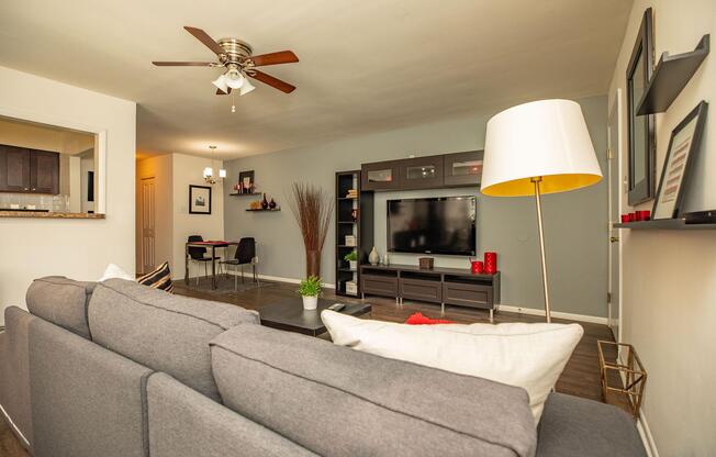 a living room filled with furniture and a flat screen tv