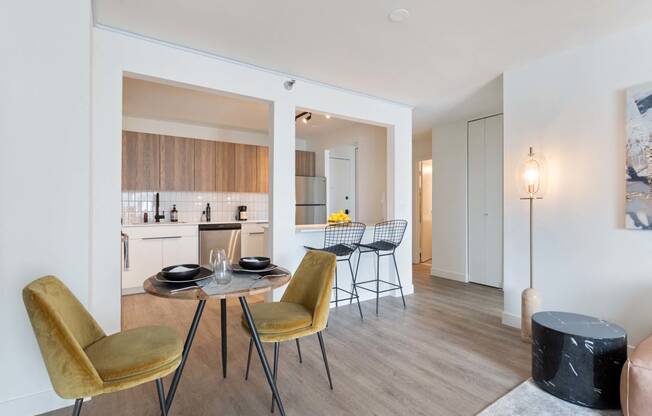 a dining room with a table and chairs and a kitchen