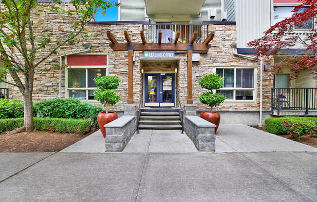 A stone building with a wooden entrance and a glass door.