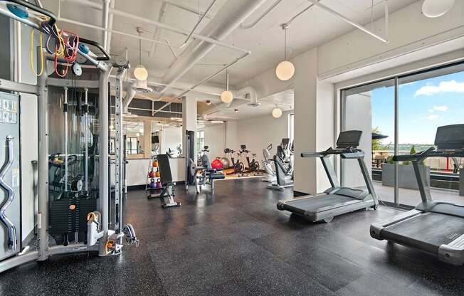 A gym with treadmills, weights, and exercise equipment.