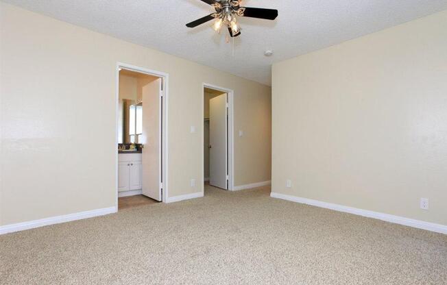 Common area with ceiling fan and carpeted floors