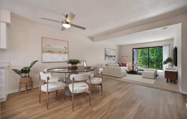 an open living room and dining room with a table and chairs