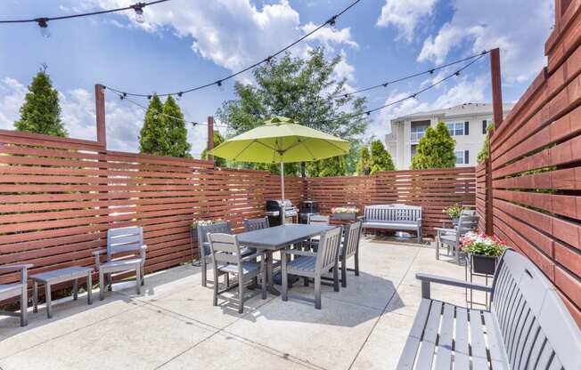 the patio has a table and chairs and an umbrella on it