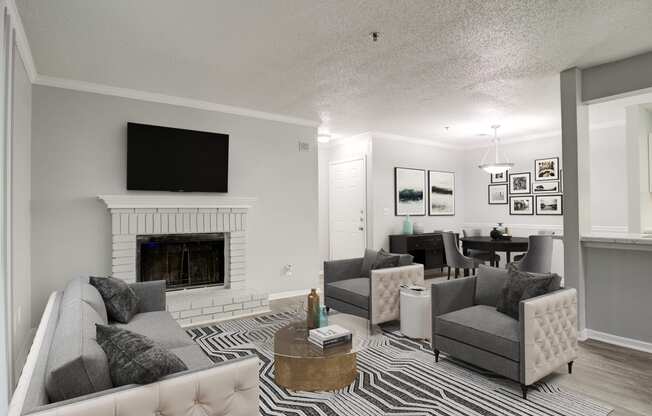 Forest Glen apartments in Austell, GA photo of a living room with a fireplace and a tv above it