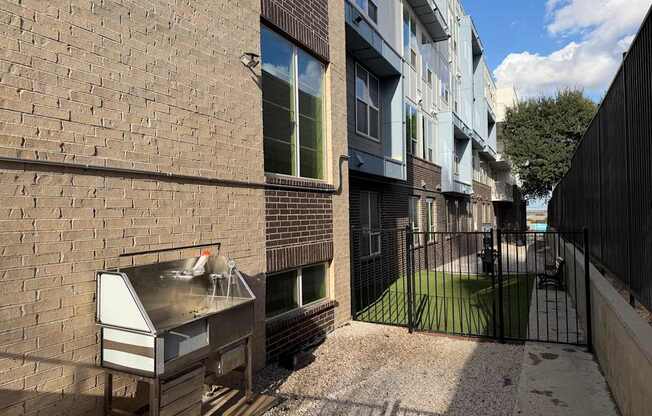 A brick wall with a grill on it.