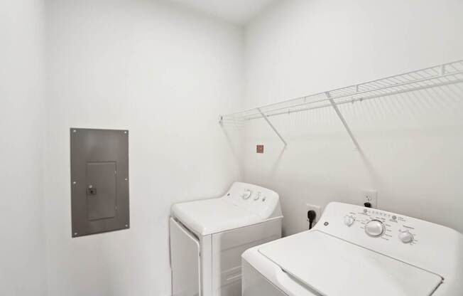 A white washing machine and dryer in a laundry room.